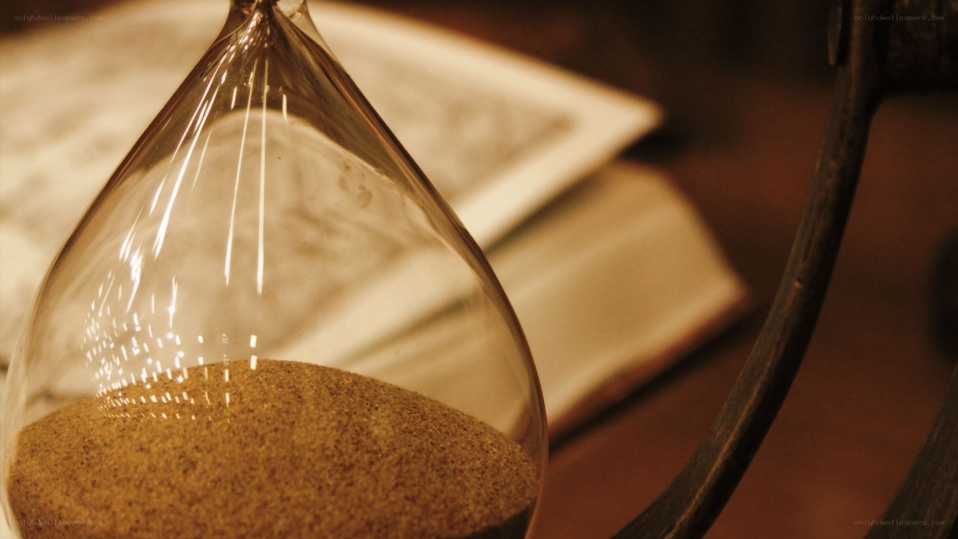 hourglass with sand and book