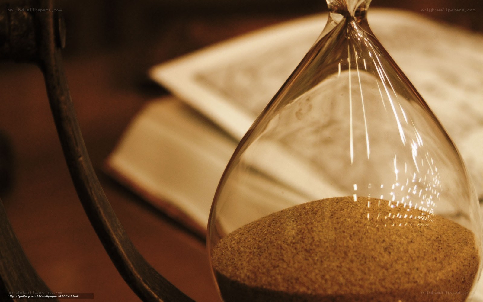 Hourglass with sand and book