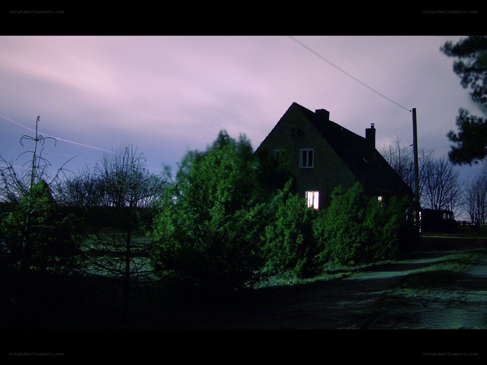 House at dusk with lit window