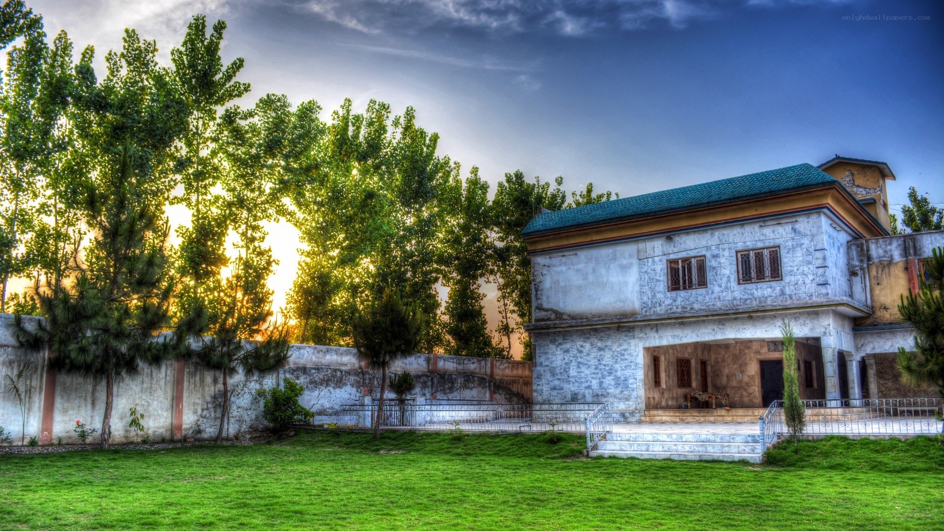 House at sunset with green lawn