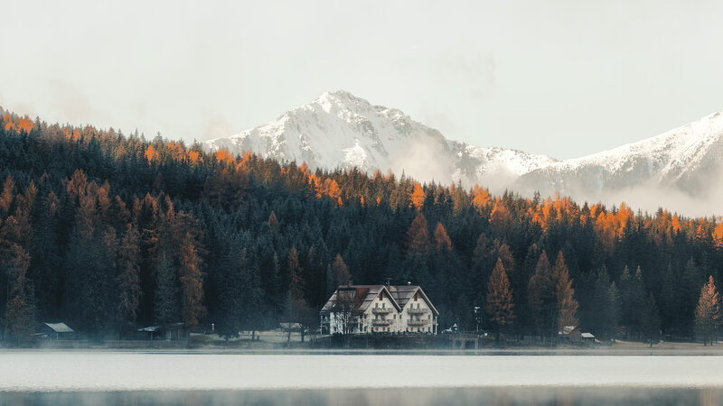 House by Lake in Mountains