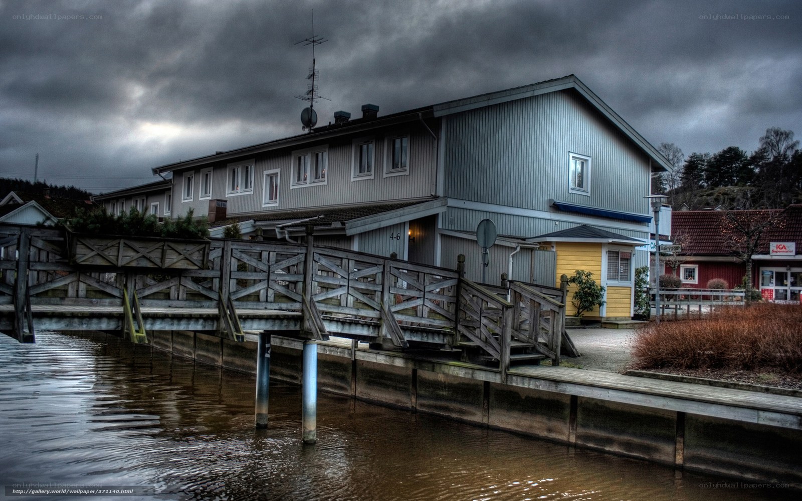 House by the water under cloudy sky