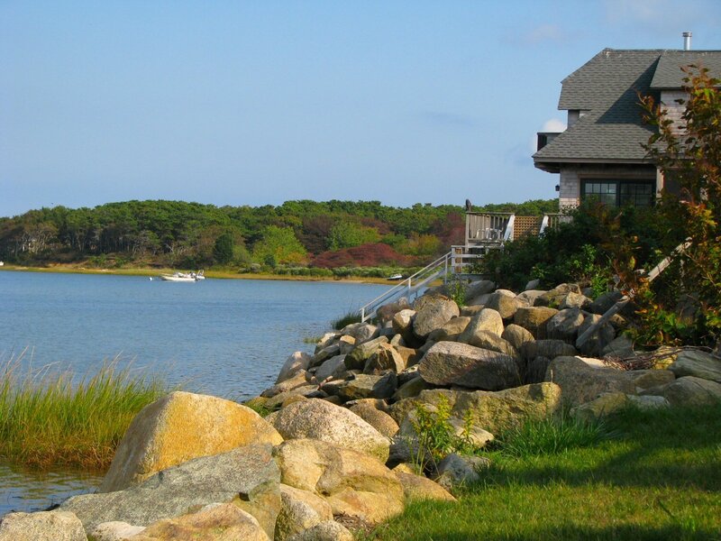 House by the water with rocky shore