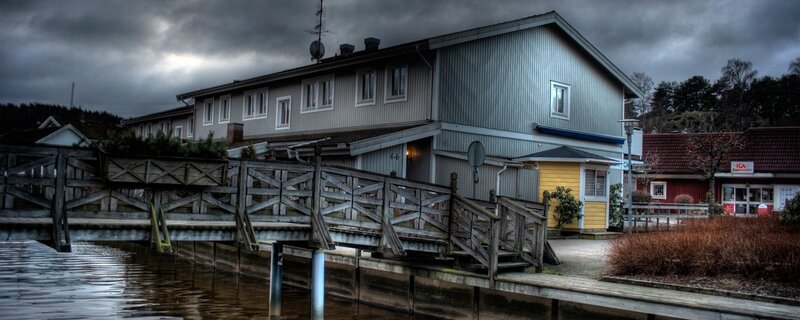House by the water with wooden bridge