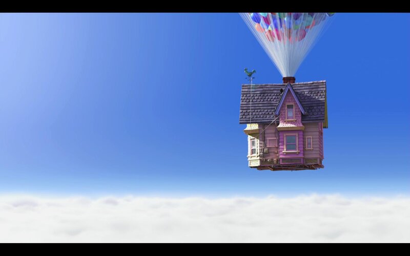 house flying with balloons