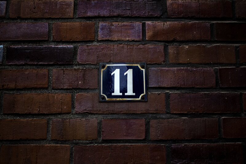 House number 11 on brick wall