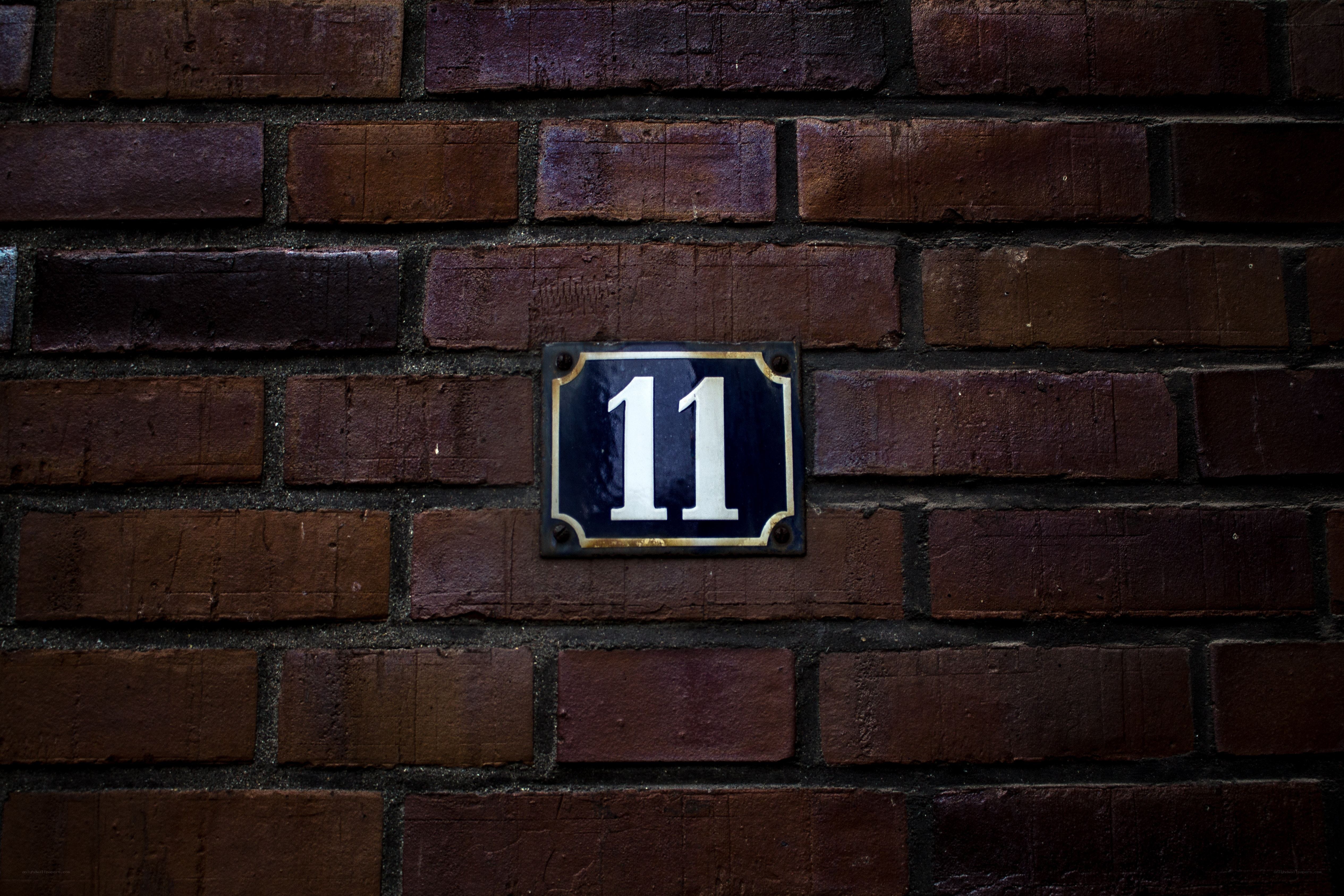 House number 11 on brick wall