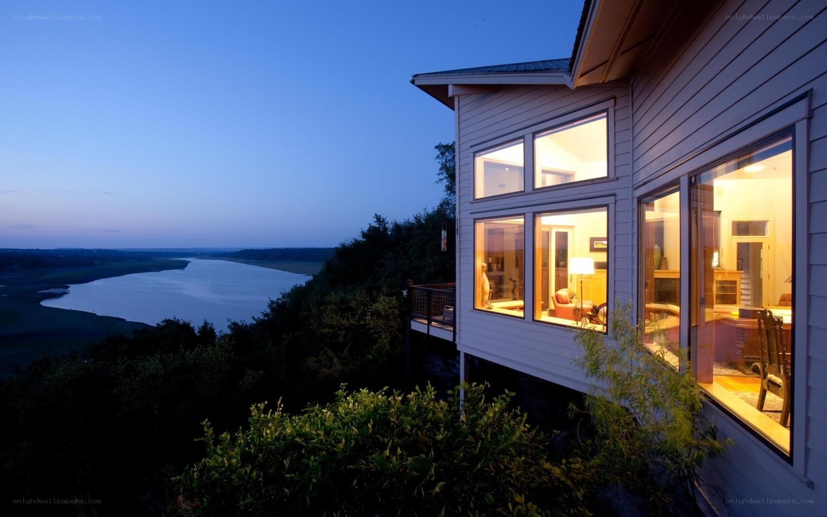 House overlooking a river at dusk