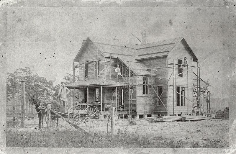 House under construction with workers
