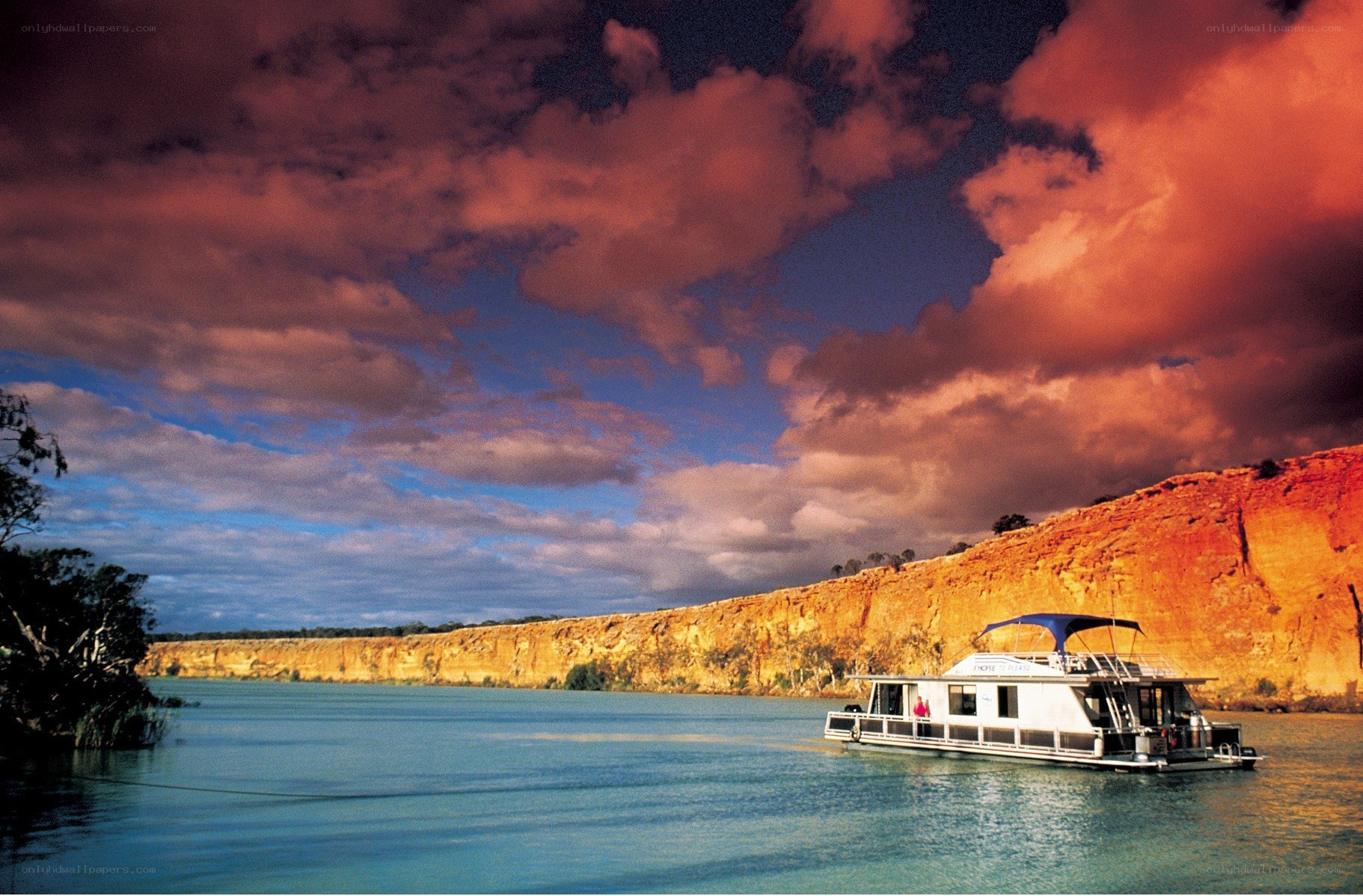 Houseboat on a river at sunset