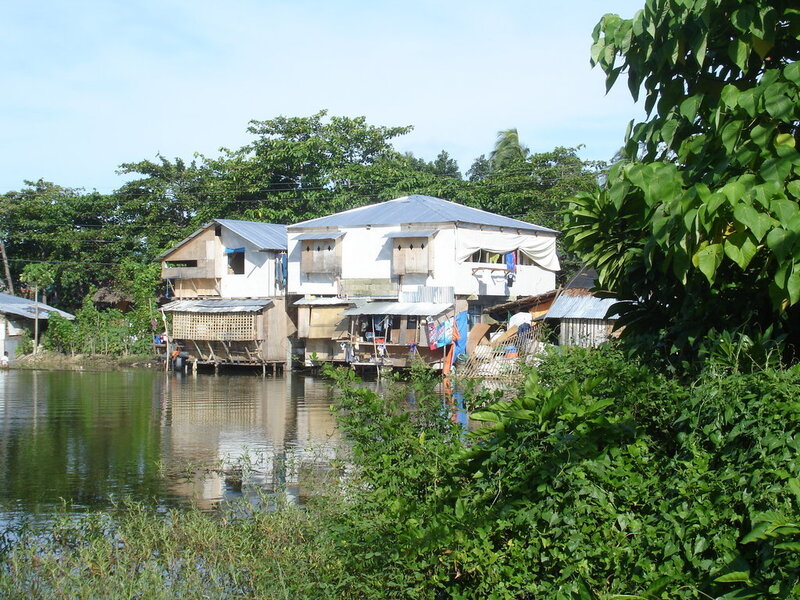 Houses on stilts by a river