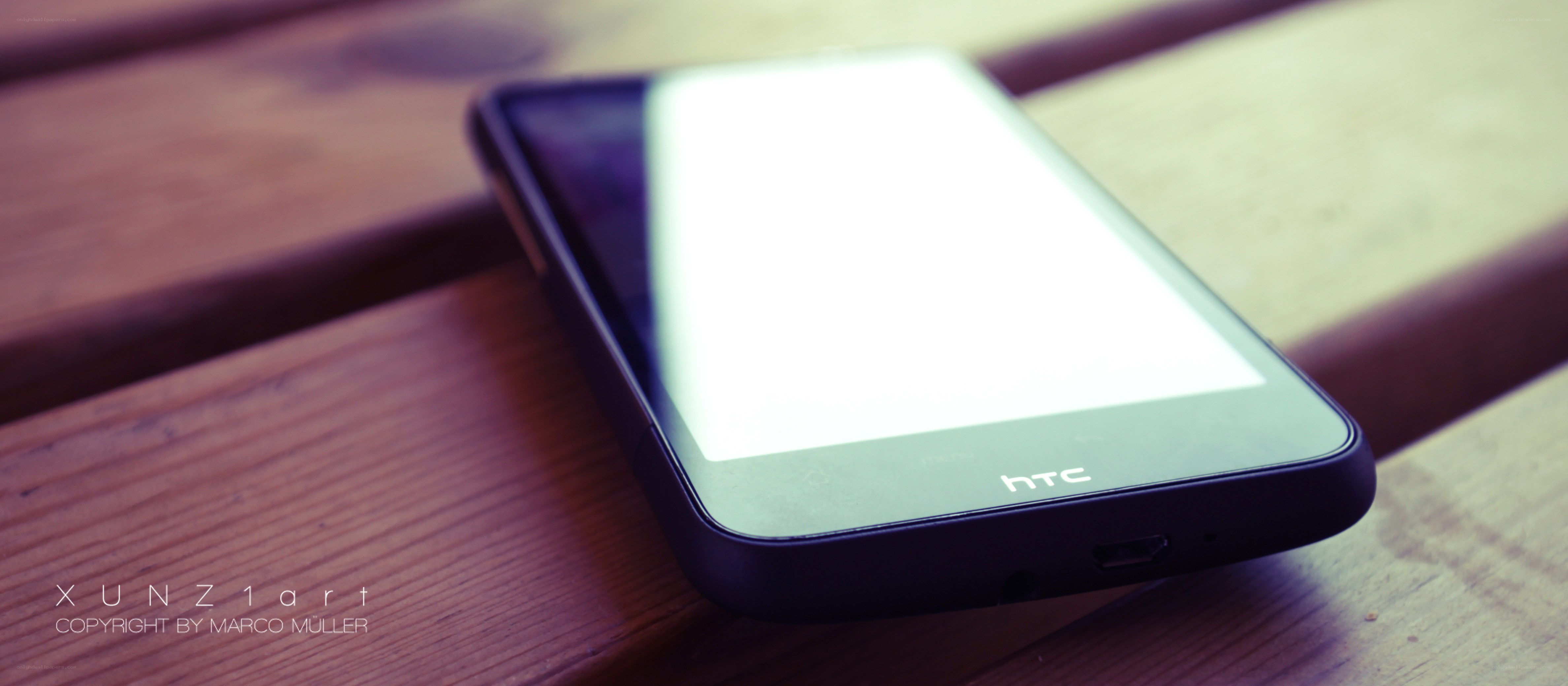 HTC phone on wooden surface