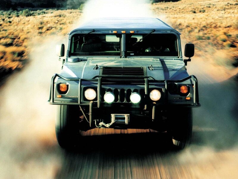 Hummer H1 driving on dirt road