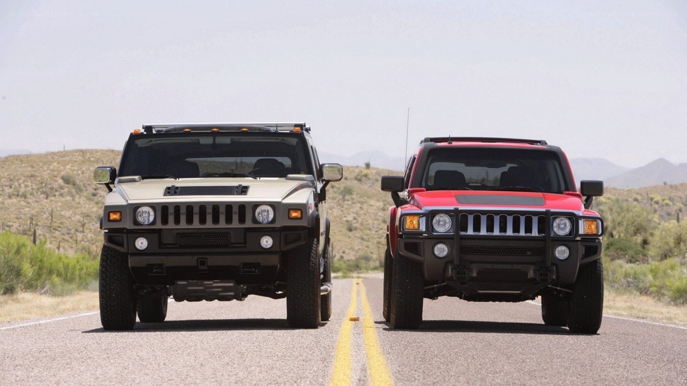 Hummer SUVs on desert road