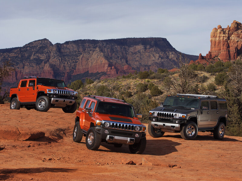 Hummer vehicles in desert landscape