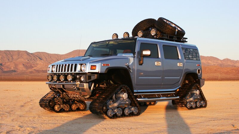 Hummer with tank tracks in desert