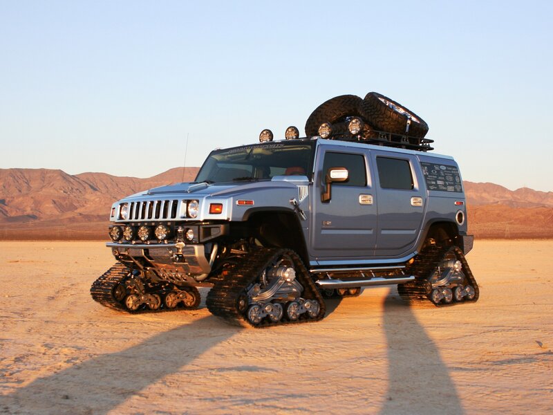 Hummer with tank treads in desert