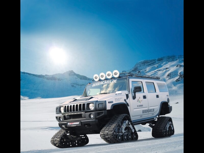 Hummer with tracks in snowy mountains