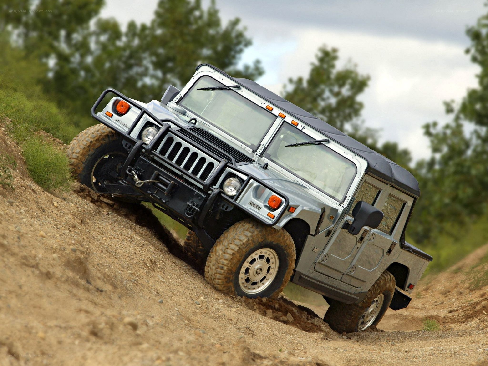 Humvee climbing a dirt hill