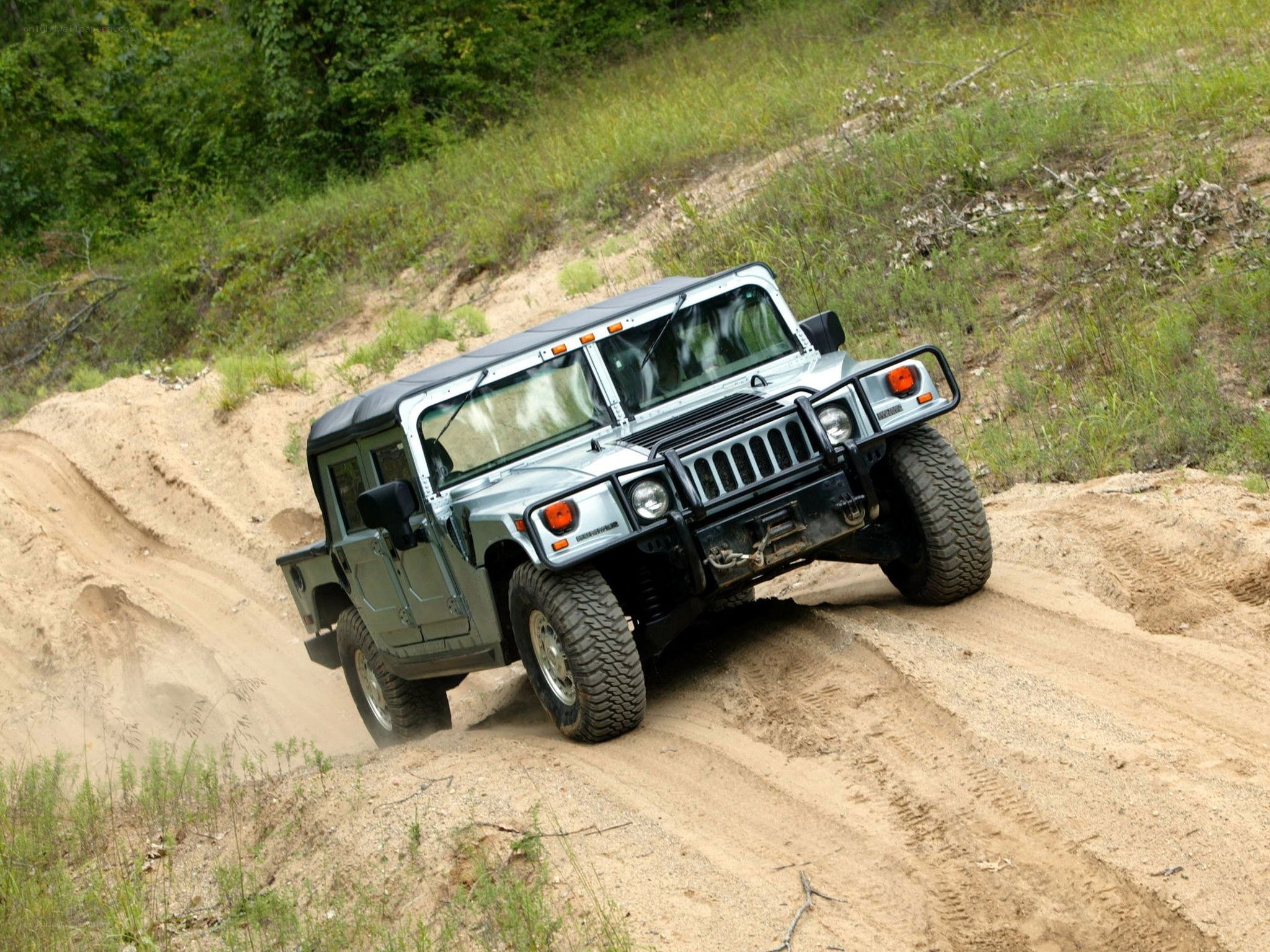 Humvee driving on dirt path
