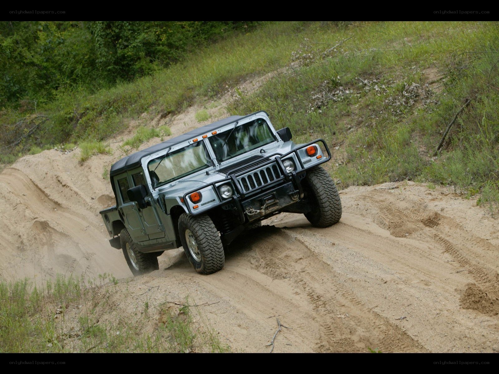 Humvee driving on dirt path