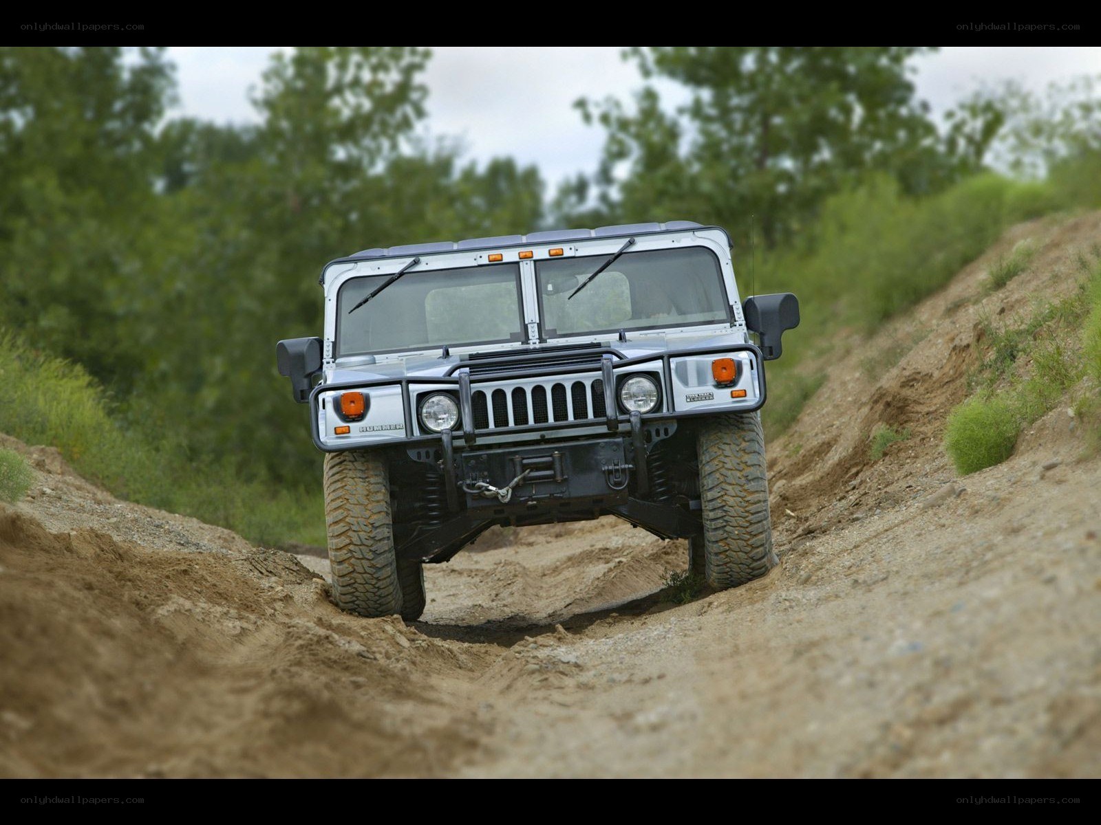 Humvee driving on dirt path