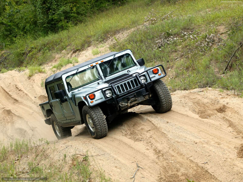 Humvee driving on dirt path