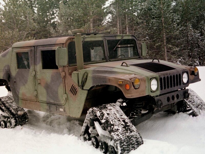 Humvee with snow tracks in forest