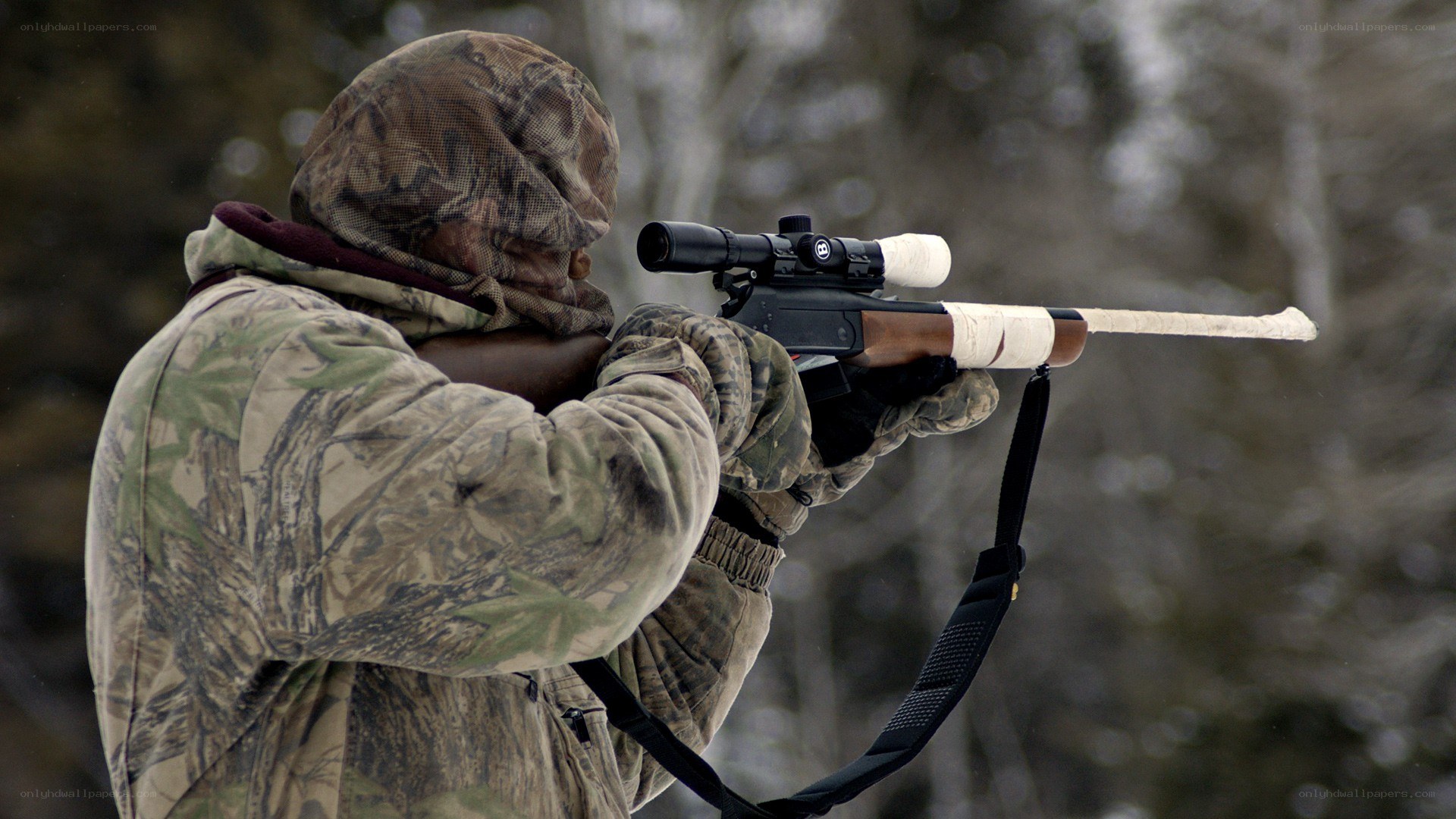 Hunter aiming rifle in forest