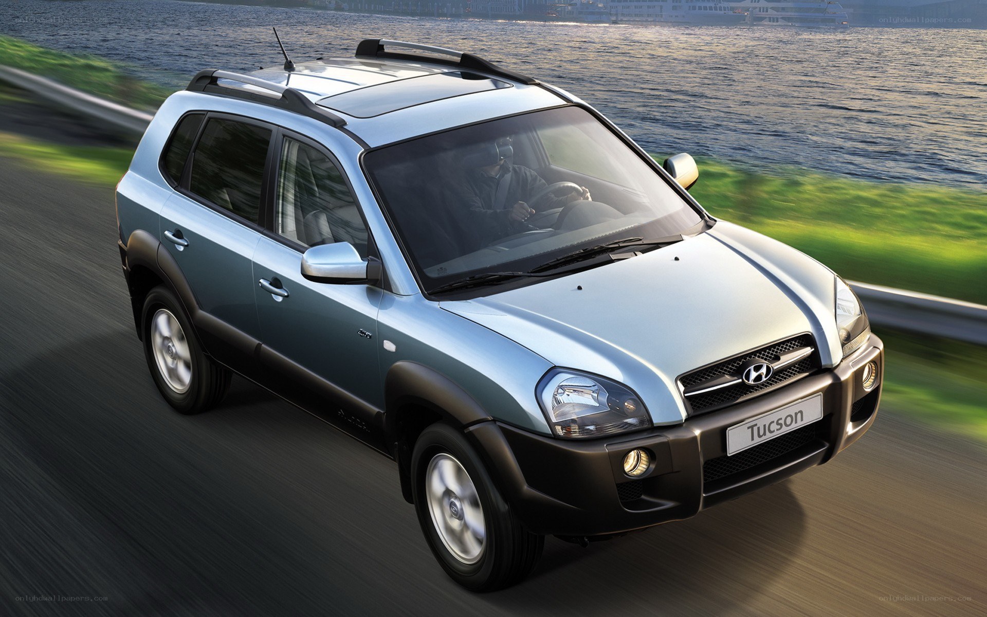 Hyundai Tucson driving on road