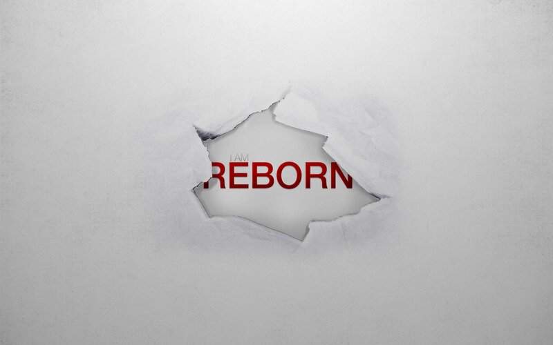 I Am Reborn text through torn paper