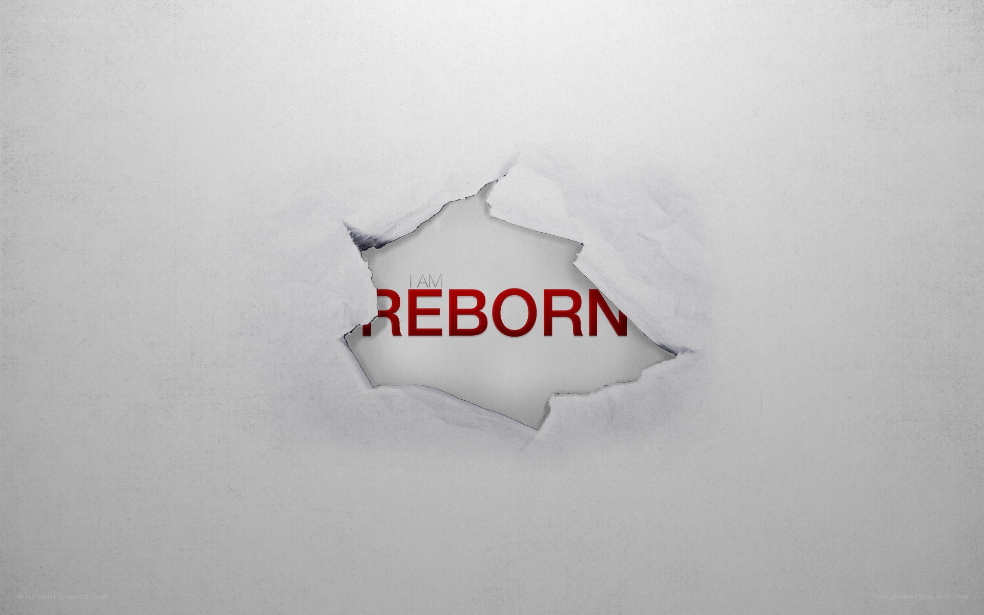 I Am Reborn text through torn paper