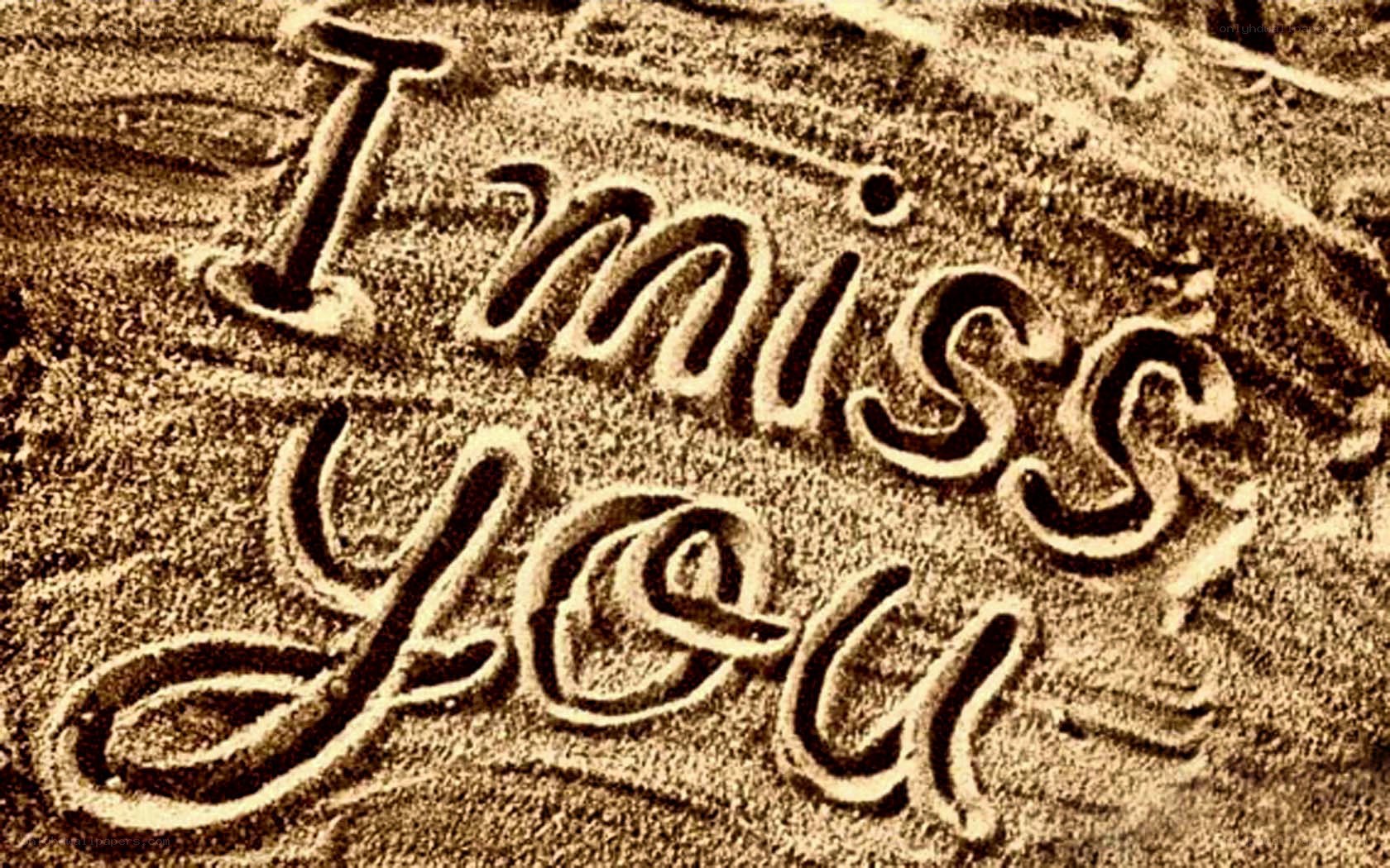 I miss you written in sand