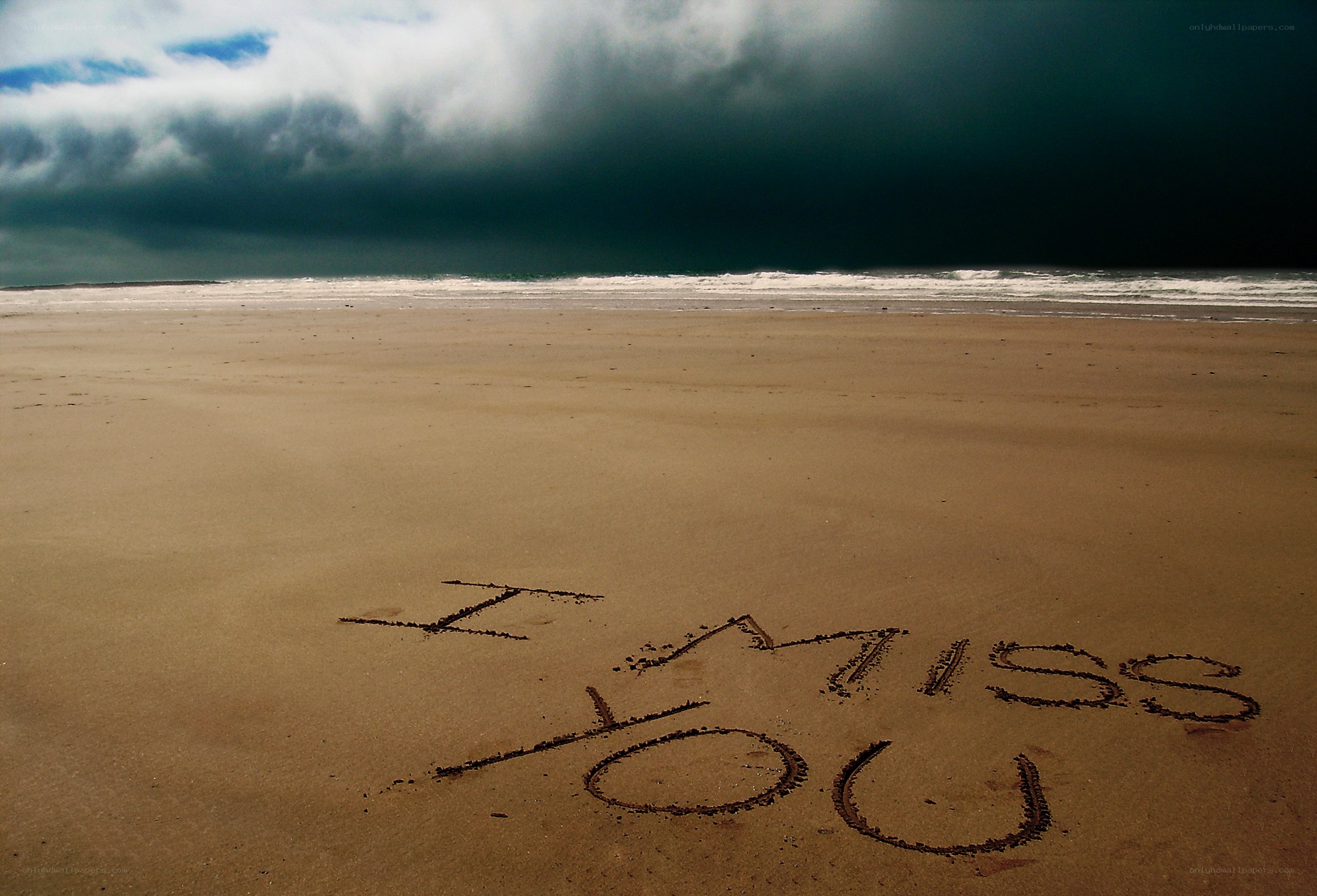 I miss you written on the beach