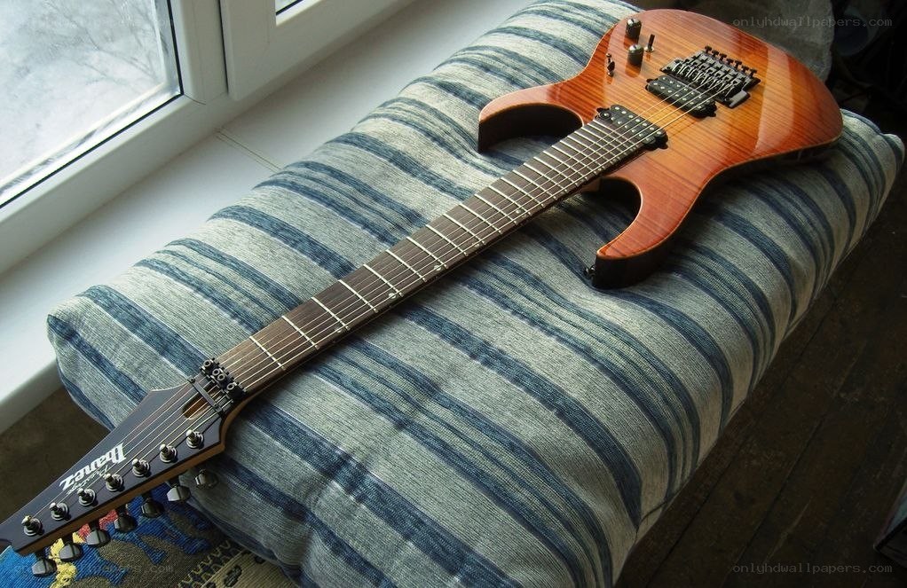 Ibanez electric guitar on cushion