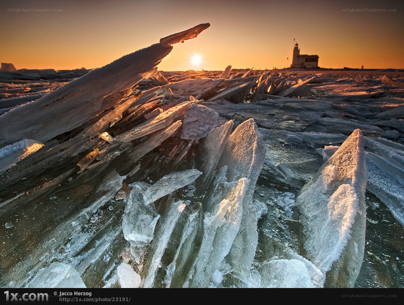 Ice and lighthouse at sunset
