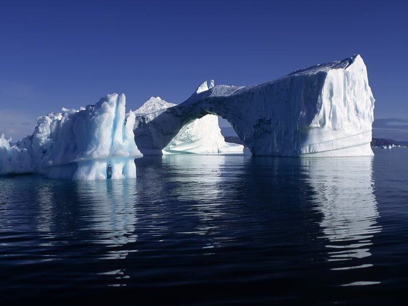 Ice arch in calm waters