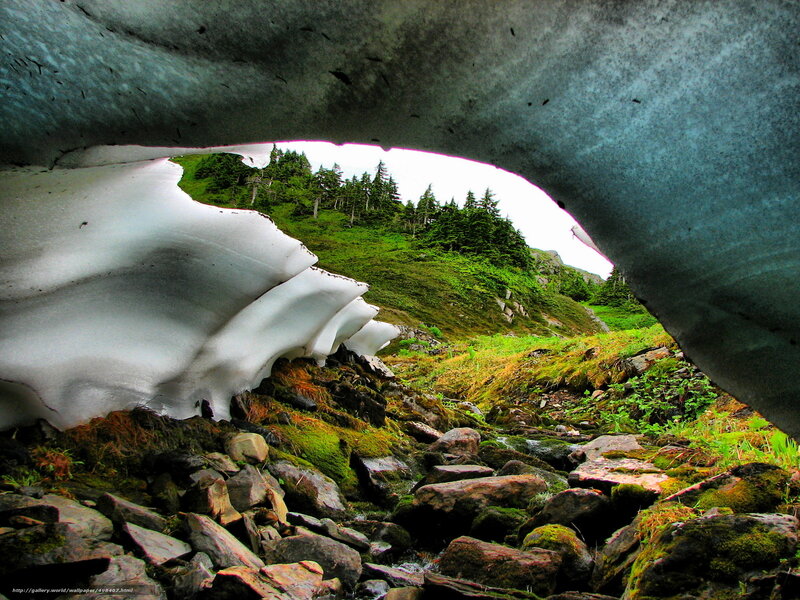 Ice cave view of green hillside