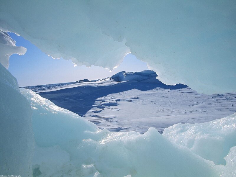 Ice cave view of snowy landscape