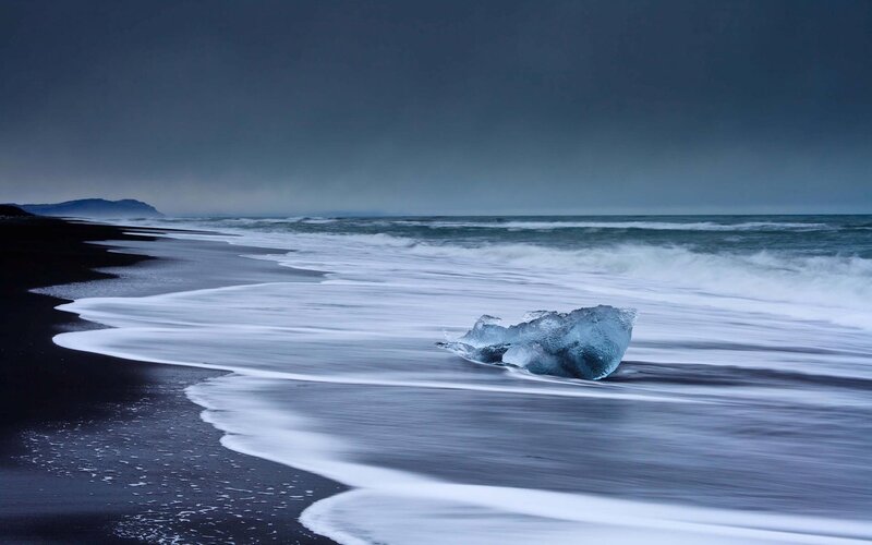 Ice Chunk on Black Sand — Blue