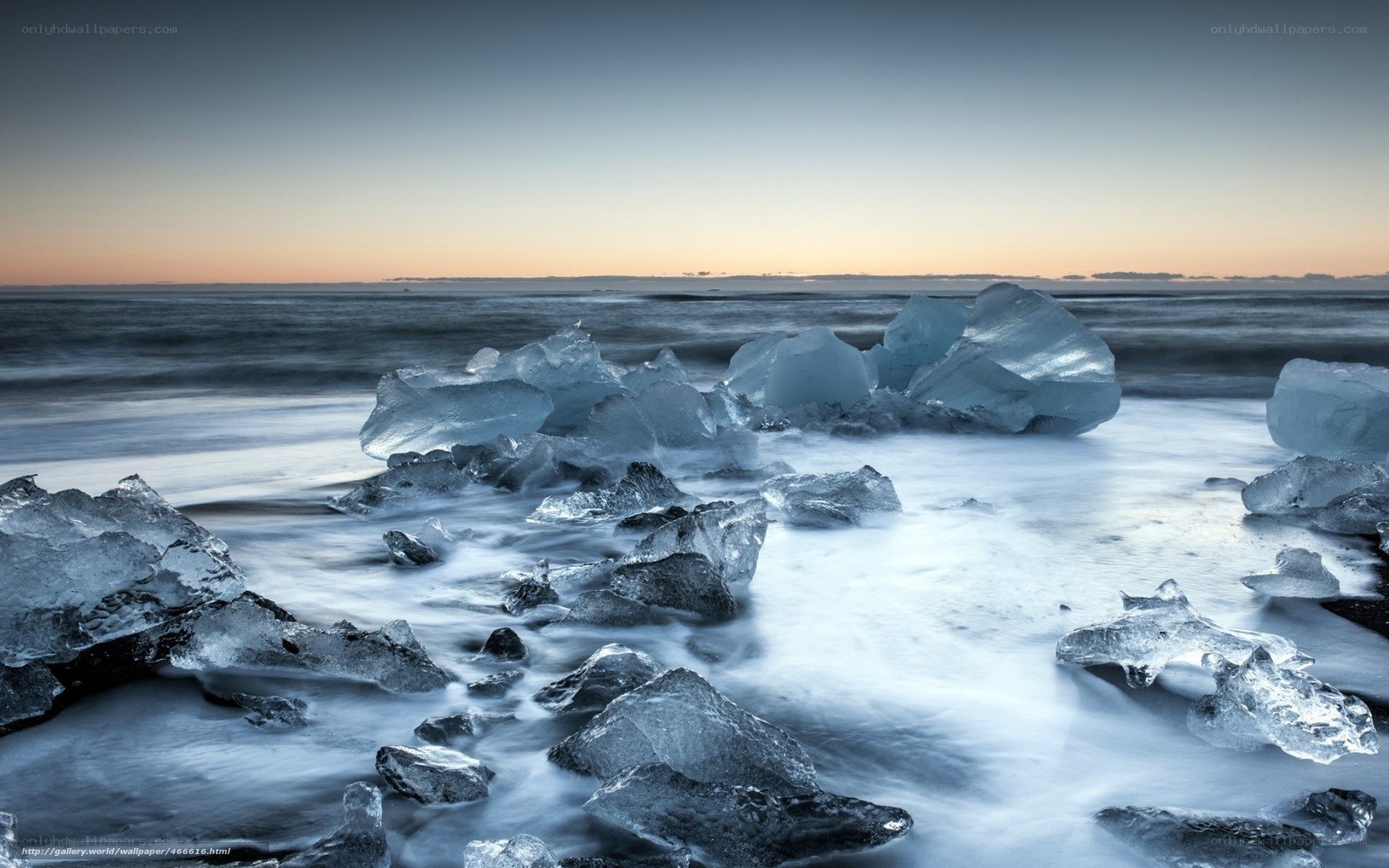 Ice chunks on a beach at dusk