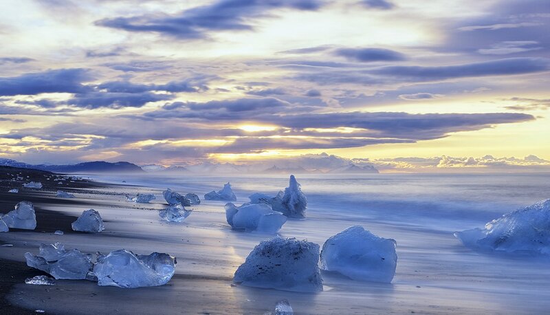 Ice Chunks on Beach — Blue, Serene, Sunset