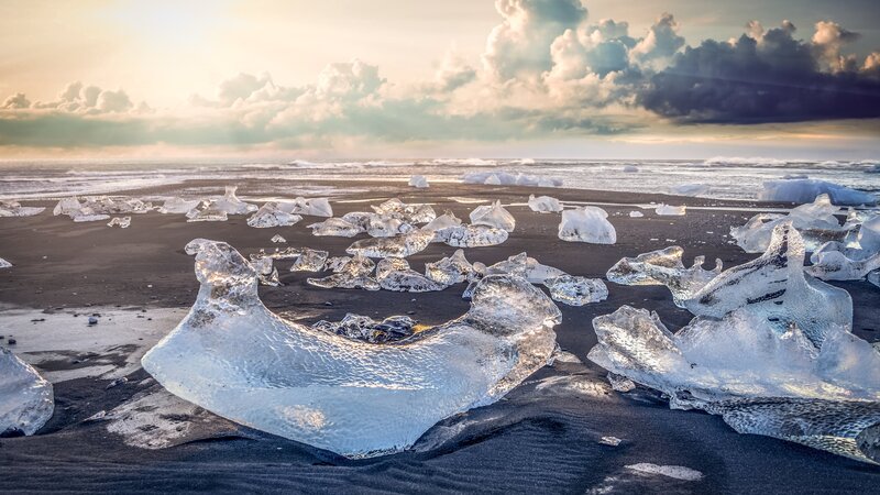 Ice Chunks on Black Sand — Dramatic, Sunset