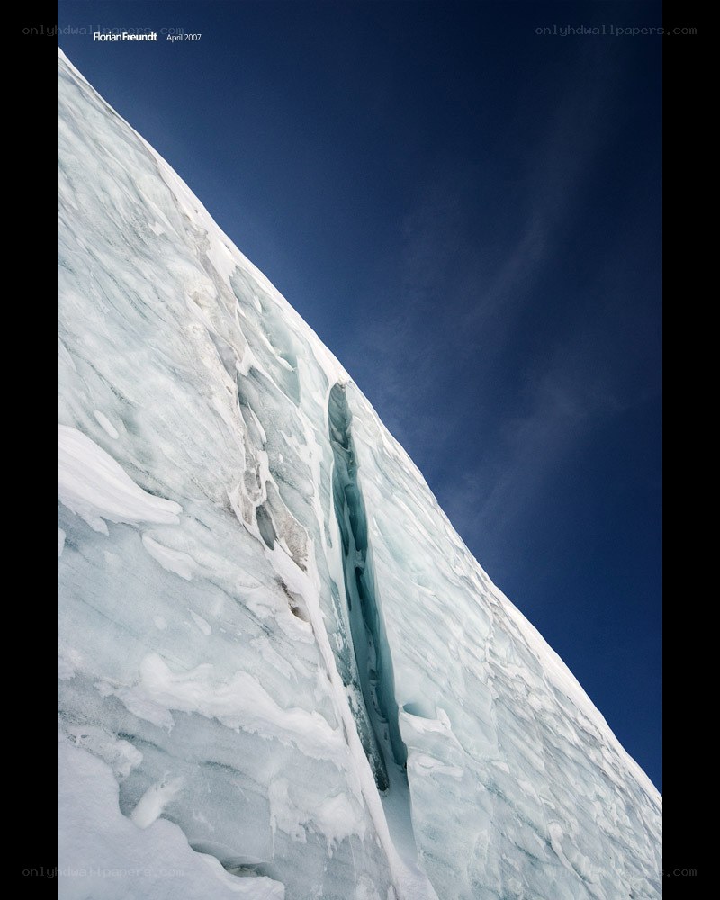 Ice cliff under blue sky