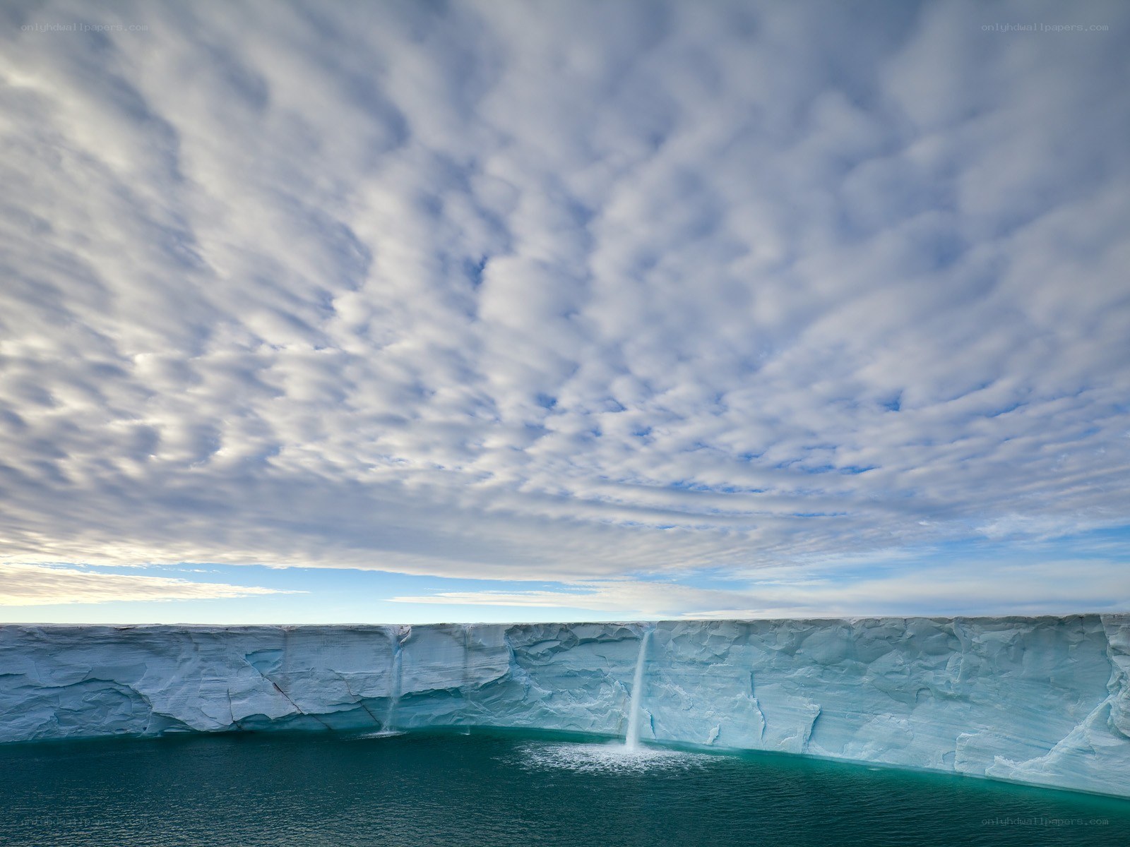 Ice cliff with waterfalls
