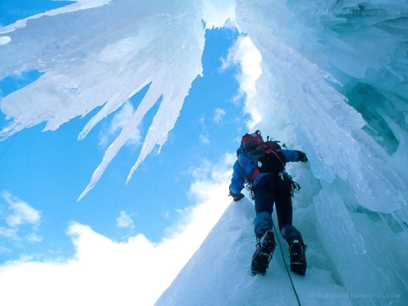 Ice climber ascending frozen waterfall