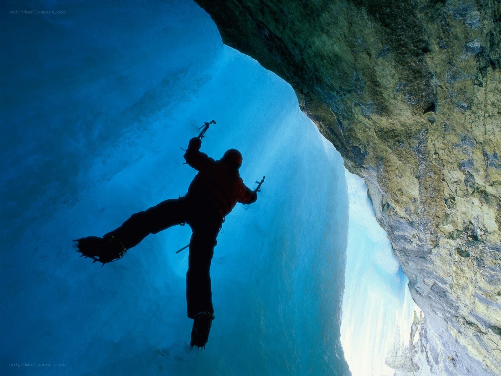 Ice climber in a blue cave