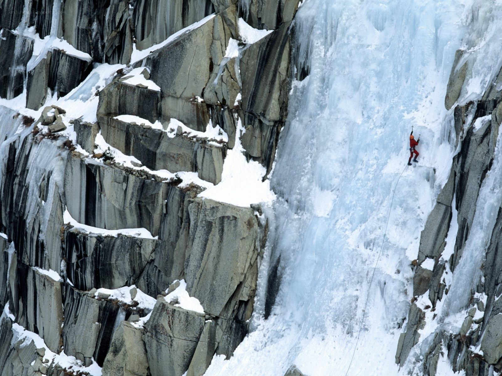 Ice climber on a frozen waterfall