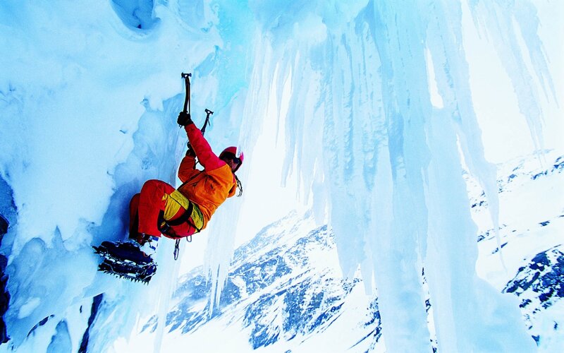 Ice Climber on Frozen Wall
