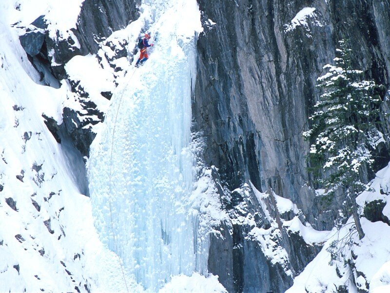Ice climber on frozen waterfall